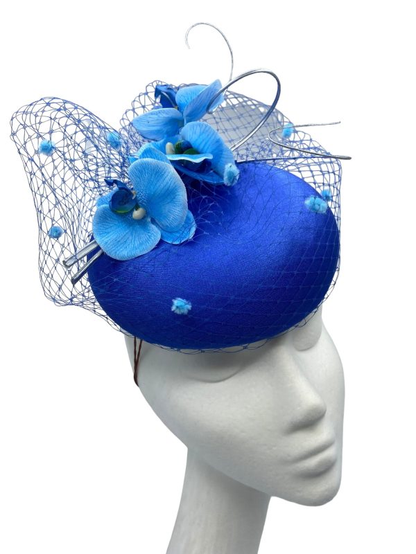 Blue headpiece with stunning lighter blue pom pom veiling and matching orchid flower detail.